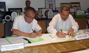 DLSAU President Narciso Erguiza, Jr and Mr. Danilo Venida of INFARMCO sign the moa on the scholarship grant.