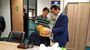 Mr. Jimmy N. Chua presents to Mark Schippers a sculpture of a smiling pig made of juniper wood to commemorate the 50th anniversary.