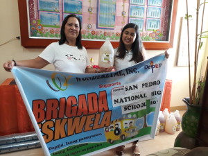 Our AE along with the Mrs. Santiago holding our company banner.